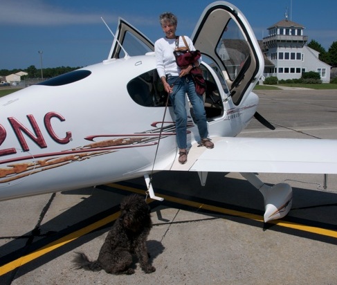 That's Bridgette, off-harness on the ground, and Gillian on the wing of Brand's plane as they arrived in Manteo.