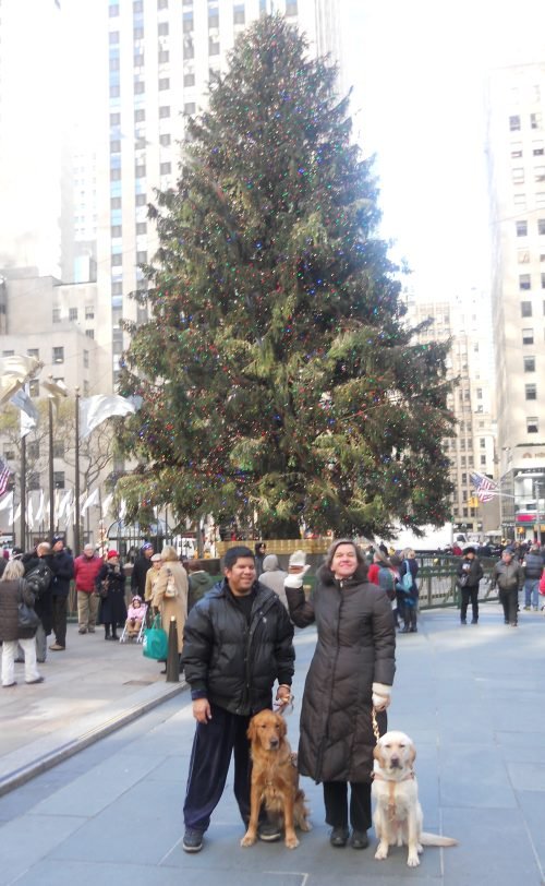 Beth and her classmate in front of the Christmas tree at Rockefeller Center.