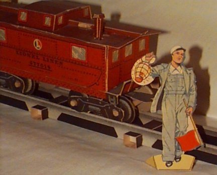 An assembled cardboard Lionel train car (and action figure).