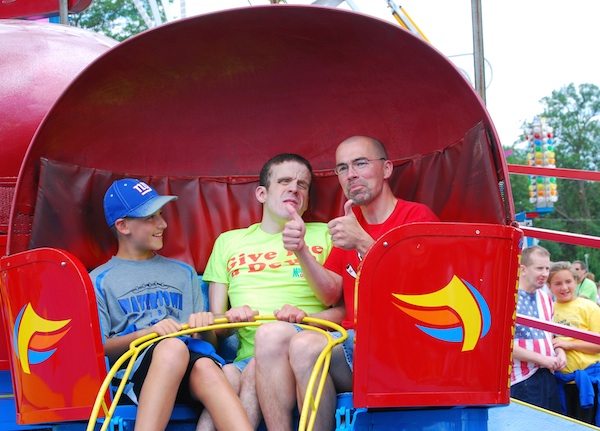 Bobby Ladwig -- a staff member at Gus' house -- took Gus and other residents to the local carnival last year. That's Bobby's son on the left. 