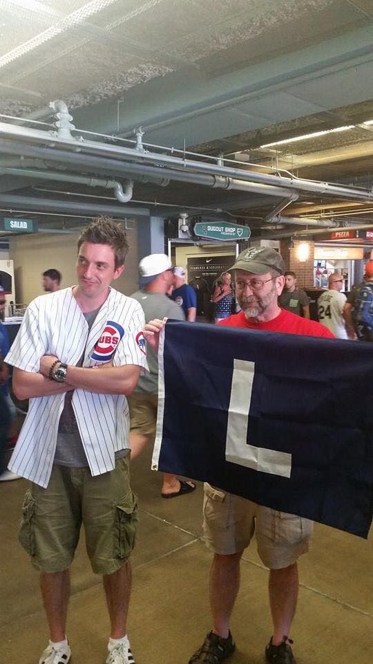 Last year Mike went to a Cubs-Sox game with some members of my family, including my nephew, Brian. The Sox won, the L flag came out, and Brian couldn't quite believe it (Also note Mike's ballcap:Marlins).