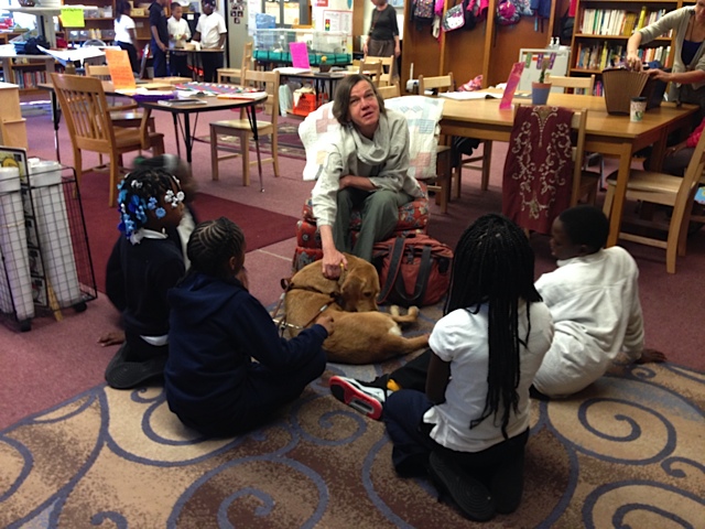 Beth Finke blind author and her seeing eye dog speaking to a small group of elementary school students in their school library