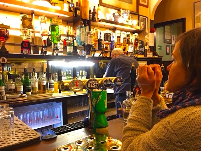 George the bartender reviews lyrics while Beth and I enjoy a pint.