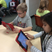 Rosalyn students looking at iPads.