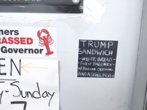 Trump Sandwich sign that says white bread, baloney, Russian dressing and a small pickle