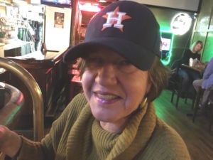 Picture of Beth in Astros cap.