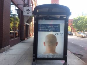 Image of one of the ads at a bus stop. 