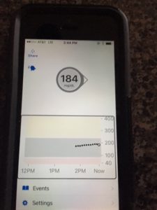 Photo of the iPhone screen with blood sugar reading of 184.