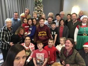 Picture of all Beth's family gathered in front of a Christmas tree.