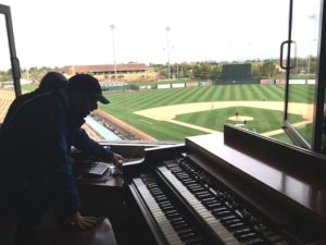 Photo of field from Nancy's booth, Eric and Joe beginning to pack up the organ.