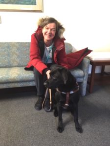 Photo of Beth and her black Lab.